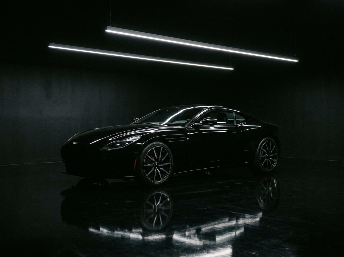 Black luxury sports car sculpted by a strip of studio light